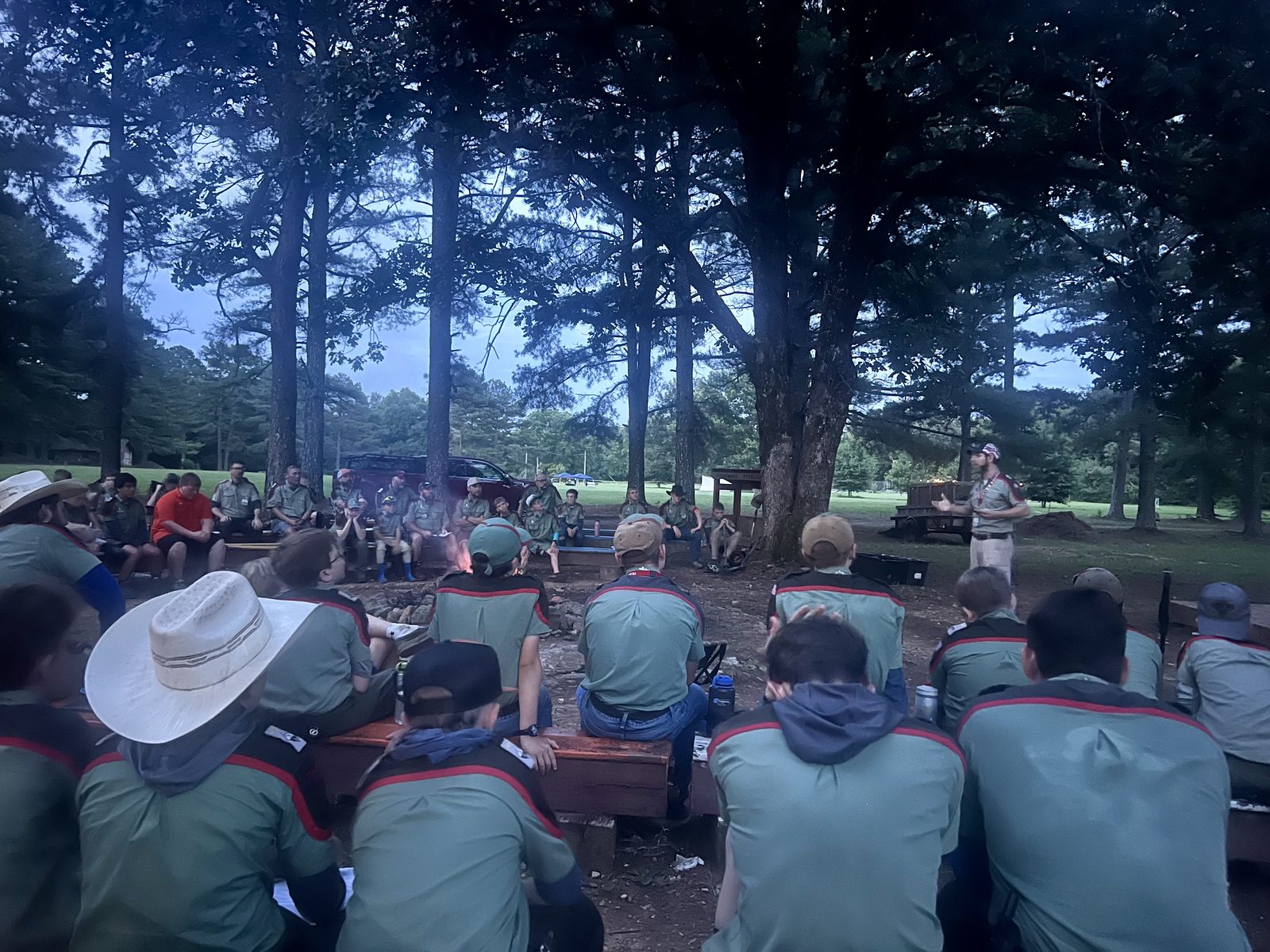 Trailmen gathered around the evening campfire circle at Camp Beacon