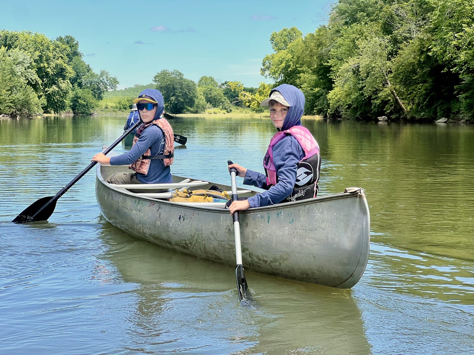 Trailmen carrying a canoe down to the water