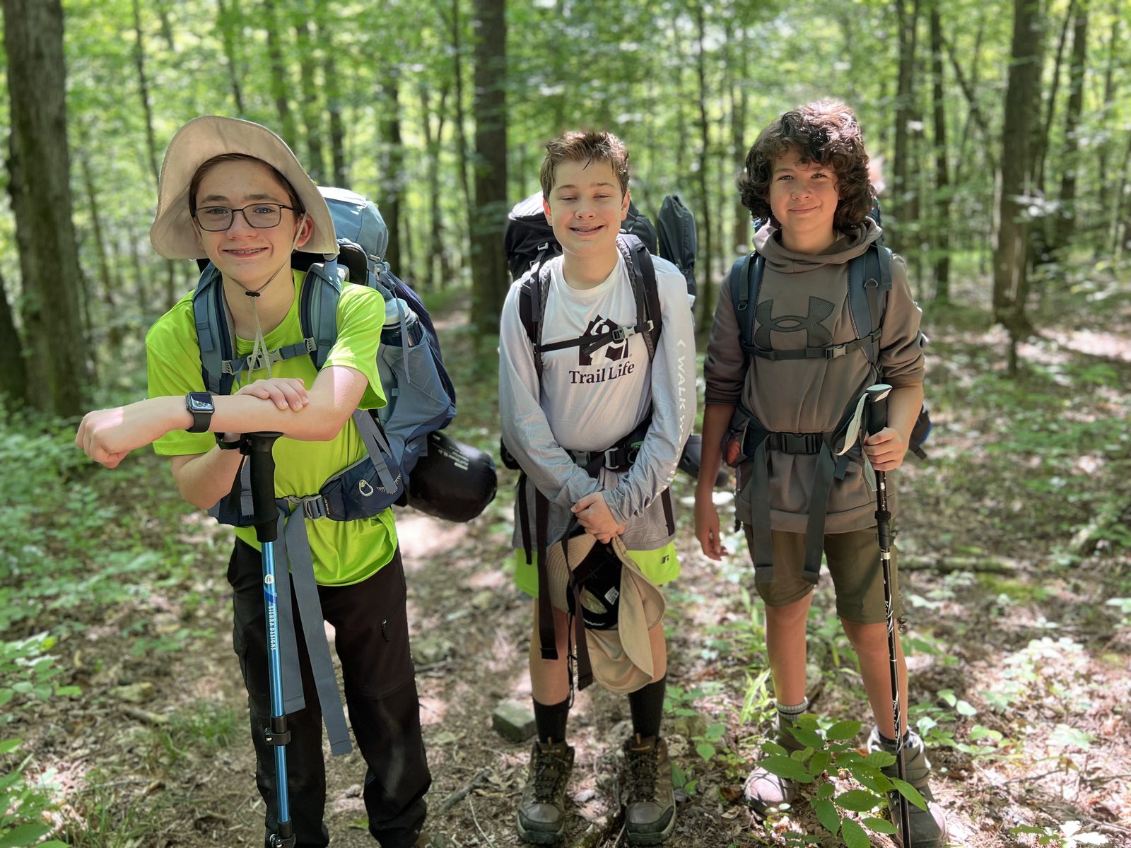 Navigators and Adventurers hiking a forest trail on the Eagle Rock Loop