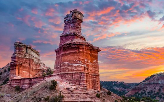 The Lighthouse rock formation at Palo Duro Canyon under a sunset sky